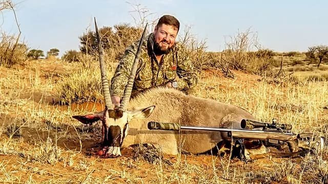 Kalahari Gemsbok Stalk Across Open Red Dunes